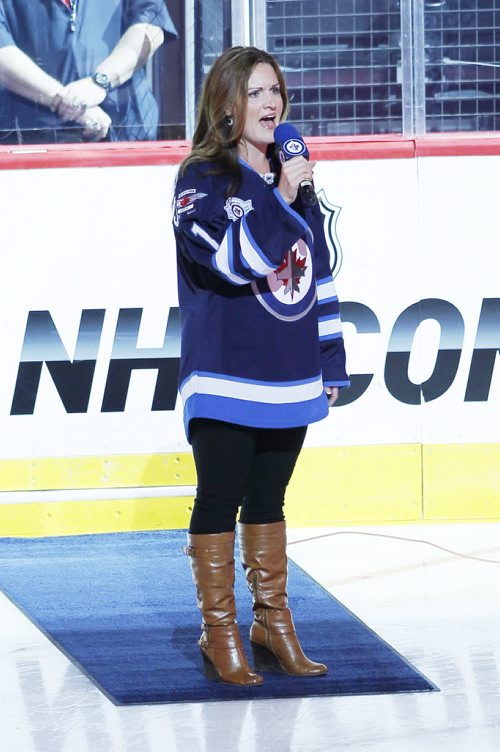 Stacey Nattrass signs the national anthem prior to pre-season NHL action between the Winnipeg Jets and Edmonton Oilers in Winnipeg on Tuesday, September 17, 2013. (John Woods / WINNIPEG FREE PRESS)