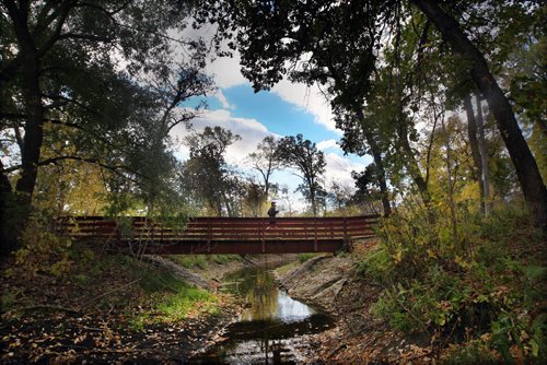 John Grivell runs across a footbridge over Truro Creek  in Bruce Park in ST James in Winnipeg Tuesday afternoon  -Standup Photo- Oct 01, 2013   (JOE BRYKSA / WINNIPEG FREE PRESS)