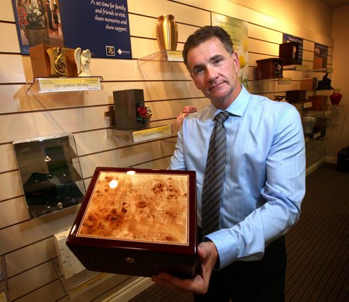 Kevin Sweryd, head of Bardal Funeral Home shows off an urn at their store front cremation arrangement office on St. Marys Road. Designed specifically for "cremation consumers" he said. See Randy Turner's tale. October1, 2013 - (Phil Hossack / Winnipeg Free Press)