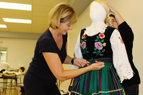 Canstar Community News Christine Tabbernor, president of the Ogniwo Polish Museum Society board (left), and Alycia Walichnowski, collections manager, adjust the costume on a manequin at the Ogniwo Polish Museum.