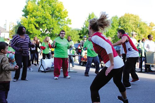 Canstar Community News Goodlife Fitness employees lead walkathon participants through a Zumba! warmup Saturday morning at the St. Amant Foundation's Free The Spirit Festival.