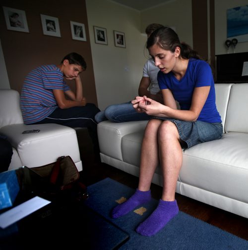 Jenny Denisenko (18) and her brother Marc (14) at home grieving their sister Carina (16) killed at a crosswalk in front of her Winkler High School Thursday. See James Turner story. October 4, 2013 - (Phil Hossack / Winnipeg Free Press)