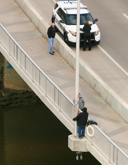 Police closed Osborne Street bridge in both directions early in the afternoon Saturday as a person stood on a light pole support at the centre of the bridge, over the Assiniboine River. 131005 - Saturday, October 05, 2013 - (Melissa Tait / Winnipeg Free Press)