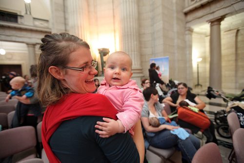 BREASTFEEDING RECORD ATTEMPTED - Melissa Tiessen-Dyck holds her 6 month old baby girl Hannah who is all smiles after nursing with 54 other moms and their babies in the Rotunda at the Leg Saturday morning to bring awareness to National Breastfeeding week. See story. Oct   03,, 2013 Ruth Bonneville Winnipeg Free Press