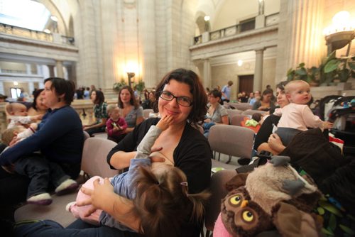 BREASTFEEDING RECORD ATTEMPTED - Tina McKenzie  nurses her 9 month old daughter  Ivy with 54 other moms and their babies in the Rotunda at the Leg Saturday morning to bring awareness to National Breastfeeding week. See story. Oct   03,, 2013 Ruth Bonneville Winnipeg Free Press