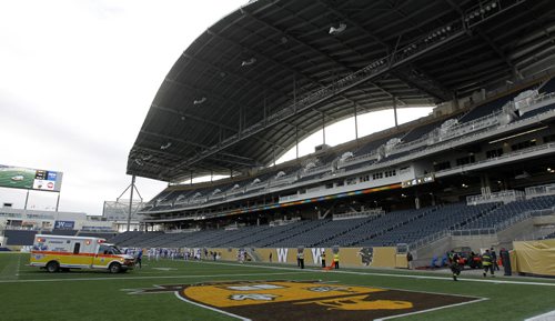 An ambulance transports UBC Thunderbirds' Miguel Barker, who lay injured on the field for about 30 minutes before being taken away during their game at against the University of Manitoba Bisons' at Investors Group Field, Saturday, October 5, 2013. (TREVOR HAGAN/WINNIPEG FREE PRESS)