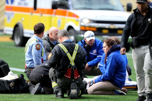 An ambulance arrives to transport while aramedics assess UBC Thunderbirds' Miguel Barker, who lay injured on the field for about 30 minutes before being taken away in an ambulance during their game at against the University of Manitoba Bisons' at Investors Group Field, Saturday, October 5, 2013. (TREVOR HAGAN/WINNIPEG FREE PRESS)
