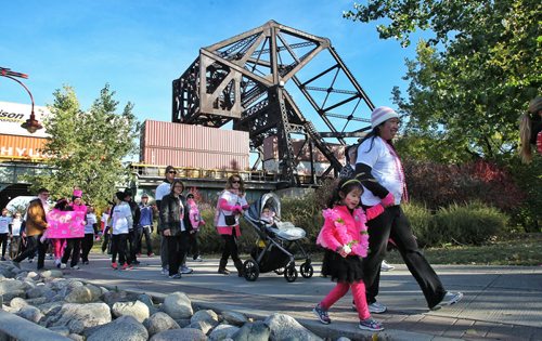 Leah Ng, 3, holds the hand of Grace Lee as they walk with other participants take in the Run for the Cure at Shaw Park Sunday morning.  131006 October 06, 2013 Mike Deal / Winnipeg Free Press