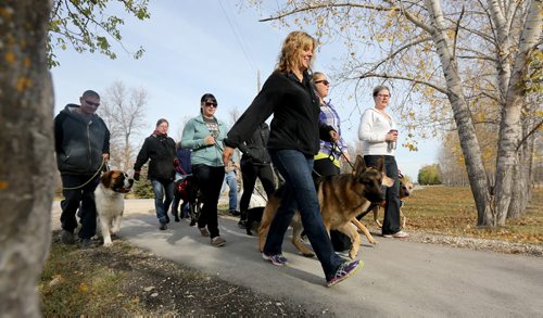 Debbi McArthur, a dog trainer, with Cash (her dog), leading a "pack walk" through St. Francois Xavier, Sunday, October 6, 2013. (TREVOR HAGAN/WINNIPEG FREE PRESS)