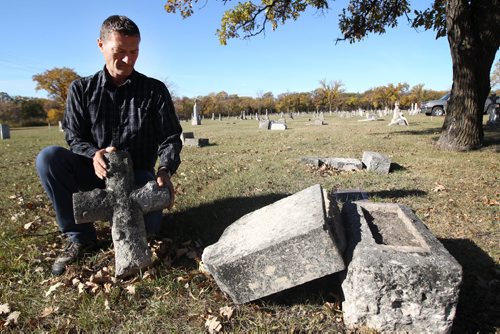 Michel Michaud caretaker at St Boniface Cemetery discovered late Friday that 25 grave markers had been knocked down and some destroyed by vandals . -See Ashley Prest story- Oct 07, 2013   (JOE BRYKSA / WINNIPEG FREE PRESS)
