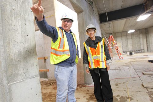 Living Water Columbarium's Monique Gauthier poses with construction site manager Phil Day at the new Catholic Church being built across from the Costco on Keniston. BORIS MINKEVICH / WINNIPEG FREE PRESS. Oct. 4, 2013