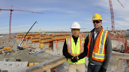 Pointe Du Bois dam tour Construction continues on the structure for the new spillway. (l-r) Barry Nazar, from Manitoba Hydro and David Eithier from Peter Kiewit Infrastructure stand on the east side of the dam while construction of the new spillway continues behind them. The dam is more than 100 years old and was built to power the Winnipeg's street cars and allow for street lights before WW I. Hydro plans to spend more than $2 billion to replace it, subject to approval. 131003 - Monday, October 07, 2013 -   MIKE DEAL / WINNIPEG FREE PRESS