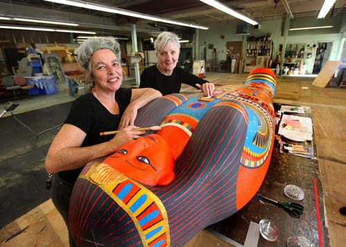 Manitoba Museum's upcoming temporary exhibit called the Mummy of Pesed includes a giant sarcophagus designed and made by artist's Anne Armit (designer - long sleeved black shirt) and Kim Forrest (artist short sleeved shirt with hair up in front). See Ashley Prest story. Oct   08,, 2013 Ruth Bonneville Winnipeg Free Press