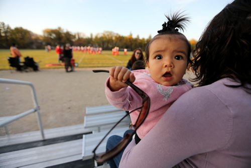 Serenity Neault, 6 months, supporting her uncle who plays for the Vincent Massey Trojans as they take on the Kelvin Clippers in High School Football at Vincent Massey Collegiate, Wednesday, October 9, 2013. (TREVOR HAGAN/WINNIPEG FREE PRESS)
