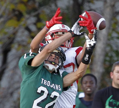 Vincent Massey Trojans' Carter Hague and Kelvin Clippers' Zack Boyko each go up to catch a ball during their high school football game at Vincent Massey Collegiate, Wednesday, October 9, 2013. (TREVOR HAGAN/WINNIPEG FREE PRESS)
