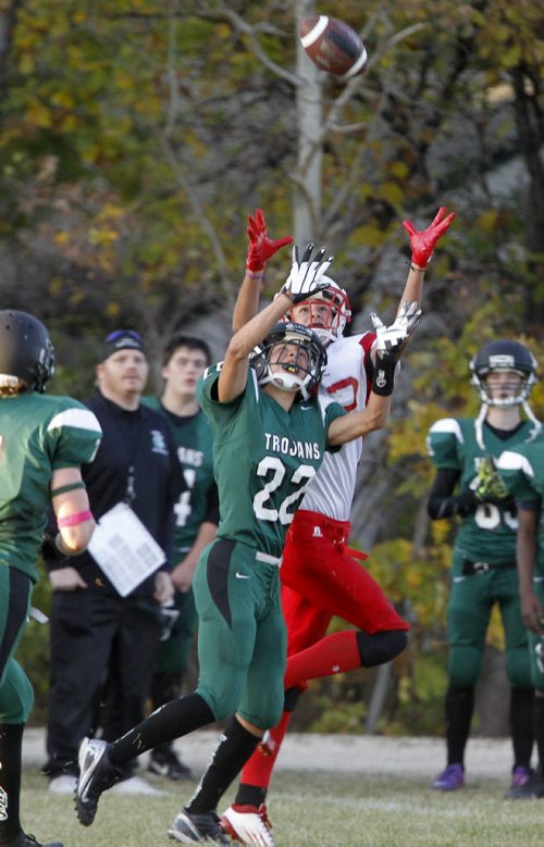 Vincent Massey Trojans' Carter Hague and Kelvin Clippers' Zack Boyko each go up to catch a ball during their high school football game at Vincent Massey Collegiate, Wednesday, October 9, 2013. (TREVOR HAGAN/WINNIPEG FREE PRESS)