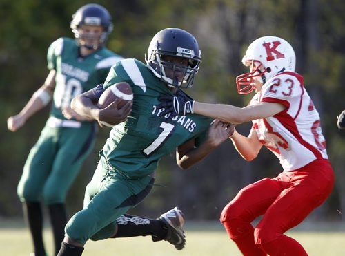 Vincent Massey Trojans' Evans Sylvestre is tackled by Kelvin Clippers' Junho Yoo during their high school football game at Vincent Massey Collegiate, Wednesday, October 9, 2013. (TREVOR HAGAN/WINNIPEG FREE PRESS)