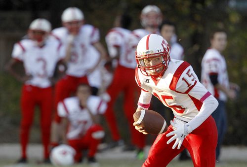 Kelvin Clippers' quarterback, Michael Raaflaub, runs out of the pocket and looks downfield to pass during the high school football game against the Vincent Massey Trojans at Vincent Massey Collegiate, Wednesday, October 9, 2013. (TREVOR HAGAN/WINNIPEG FREE PRESS)