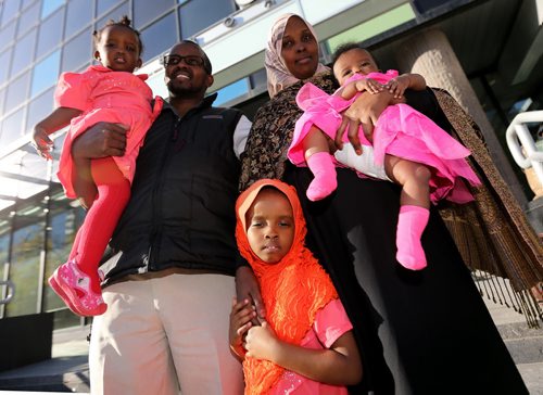 Liiban Shire Ali and Sahra Abdikarim Farah with their children, Bahja Liiban Ali, 1 year, Bushra Ali, 4 years, and Bayaan Liiban Ali, 4mo, outside the courts at 363 Broadway, Wednesday, October 9, 2013. (TREVOR HAGAN/WINNIPEG FREE PRESS) - for carol sanders story