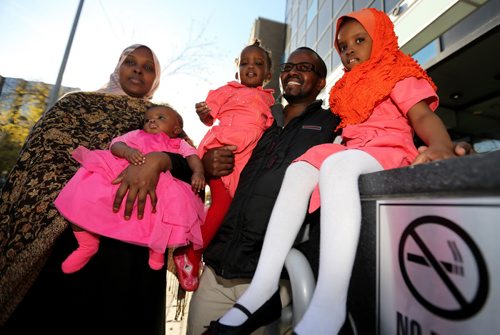 Sahra Abdikarim Farah and her husband Liiban Shire Ali, with their children, Bayaan Liiban Ali, 4mo, Bahja Liiban Ali, 1 year, and Bushra Ali, 4 years, outside the courts at 363 Broadway, Wednesday, October 9, 2013. (TREVOR HAGAN/WINNIPEG FREE PRESS) - for carol sanders story