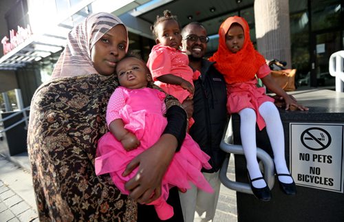 Sahra Abdikarim Farah and her husband Liiban Shire Ali, with their children, Bayaan Liiban Ali, 4mo, Bahja Liiban Ali, 1 year, and Bushra Ali, 4 years, outside the courts at 363 Broadway, Wednesday, October 9, 2013. (TREVOR HAGAN/WINNIPEG FREE PRESS) - for carol sanders story