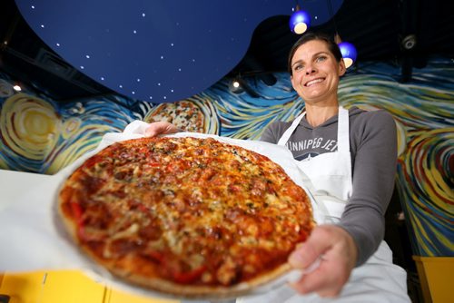 Elizabeth Wagner, owner of Van Goes Pizza holding the "Starry Night" pizza, one of their masterpieces, Thursday, October 10, 2013. (TREVOR HAGAN/WINNIPEG FREE PRESS)