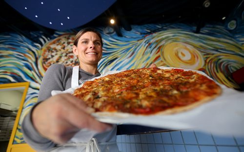 Elizabeth Wagner, owner of Van Goes Pizza holding the "Starry Night" pizza, one of their masterpieces, Thursday, October 10, 2013. (TREVOR HAGAN/WINNIPEG FREE PRESS)