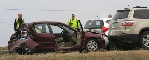 The crash scene of three vehicles that collided with a semi trailer on the south Perimeter Hwy. near Budd Rd. Friday morning.Wayne Glowacki / Winnipeg Free Press Oct. 11 2013