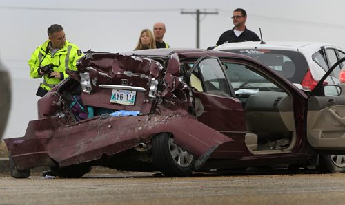 The  crash scene of three vehicles that collided with a semi trailer on the south Perimeter Hwy. near Budd Rd. Friday morning.Wayne Glowacki / Winnipeg Free Press Oct. 11 2013