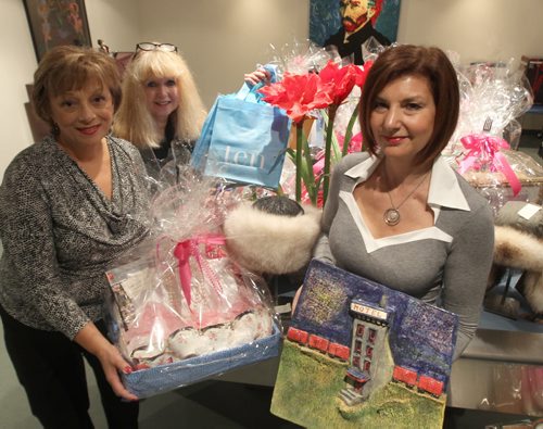 L to R Vivian Albo, Trish Wood and Haderra Chisick with some of the auction prizes  for the Guardian Angel Cancer Care tea and fund raiser.See Gordon Sinclair story- Oct 11, 2013   (JOE BRYKSA / WINNIPEG FREE PRESS)
