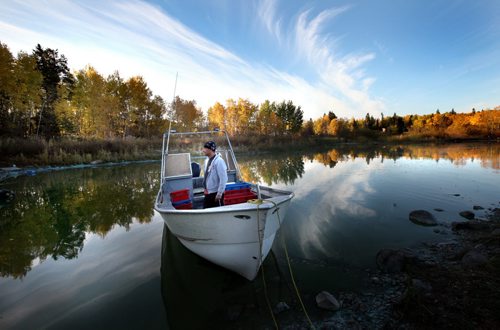Readying their fishing boat, Rick Bushie savors the morning as fall is reflected in their Lake WInnipeg Harbor. Harvey Bushie and his son Rick harvest fish from the Lake Winnipeg Waters near Hollow Water. October 9, 2013 - (Phil Hossack / Winnipeg Free Press)