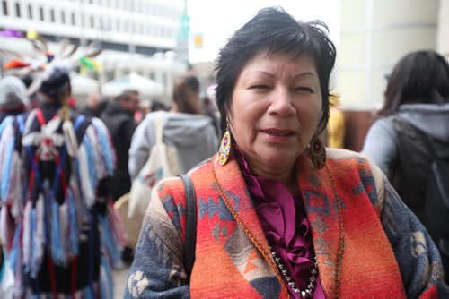 Reporter Mary Agnes Welch asks indigenous people gathering for a healing dance on Portage and Main Street Saturday morning about their views on voting to go with upcoming story.  Rose Hart answers questions from reporter on voting.  See MA's story. Oct   12,, 2013 Ruth Bonneville Winnipeg Free Press