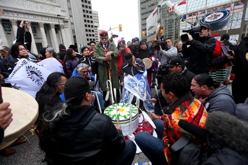 A large group of  drummers and jingle dancers gathered together at the corner of Portage and Main welcoming the UN Special Rapporteur on the Rights of Indigenous Peoples Saturday morning.  Oct   12,, 2013 Ruth Bonneville Winnipeg Free Press