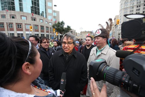 James Anaya, Special Rapporteur on the Rights of Indigenous Peoples, talks with the press on the corner of Portage and Main Saturday during just before a  healing dance that saw hundreds dancers, drummers and supporters  gather together in support of Aboriginal rights. Oct   12,, 2013 Ruth Bonneville Winnipeg Free Press