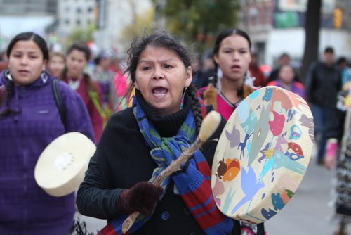 Jingle dancers and drummers  march their way down Main street toward Thunderbird House with a large group of jingle dancers and drummers that headed up a march welcoming the UN Special Rapporteur on the Rights of Indigenous Peoples Saturday morning.  Oct   12,, 2013 Ruth Bonneville Winnipeg Free Press