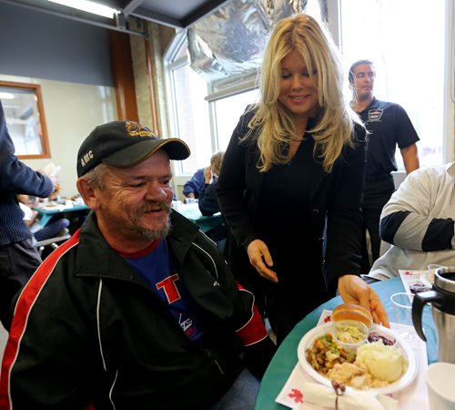 Donna D'Errico, who once starred on Baywatch, serves a Thanksgiving meal to Joe Richard at Siloam Mission, Monday, October 14, 2013. (TREVOR HAGAN/WINNIPEG FREE PRESS)