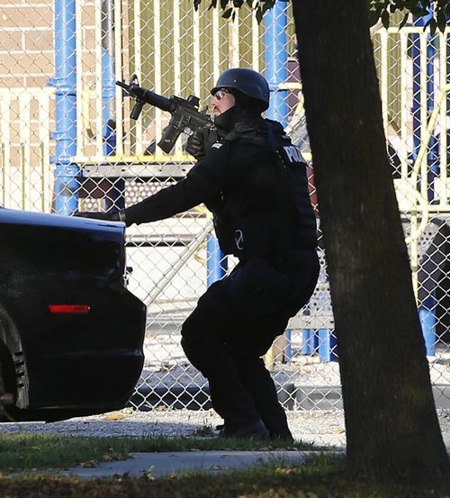 Tense standoff finished -PoliceK-9 &  tactical team has finished searched the house and are outside- could not see if they took anyone in -  Wpg Police have a  St. John's Ave  2 ¬½ story house a few houses from Faraday School  surrounded with  and have take one person out , the area around ST. John's , Mountain ave Parr and Mckenzie   is still closed after tactical team re entered the house  KEN GIGLIOTTI / Oct. 16 2013 / WINNIPEG FREE PRESS