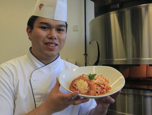 49.8 - rrc food column.  Alex Wong with his  Chicken Parmigiana  in the kitchen of the RRC School of Hospitality and Culinary Arts. Keith F. Müller story Wayne Glowacki / Winnipeg Free Press Oct. 16 2013