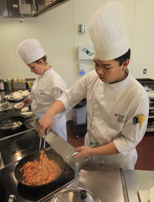 49.8 - rrc food column. At right, Alex Wong prepares pasta for Chicken Parmigiana with Mae Berard starts to prepare Fettuccini Alfredo in the kitchen of the RRC School of Hospitality and Culinary Arts. Keith F. Müller story Wayne Glowacki / Winnipeg Free Press Oct. 16 2013