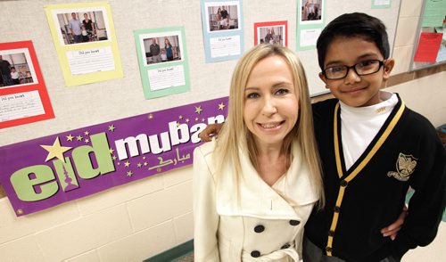 Kaleem Siddiqui, 6, and his teacher, Nancy Jacobson, with the banner that he provided for his grade two class at SJR where he also gave a speech for the school about muslim religion. 131016 - October 16, 2013 MIKE DEAL / WINNIPEG FREE PRESS