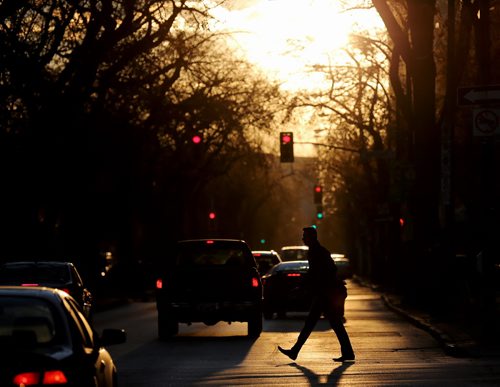 Pedestrians walk across Broadway in the setting sun, Thursday, October 17, 2013. (TREVOR HAGAN/WINNIPEG FREE PRESS)