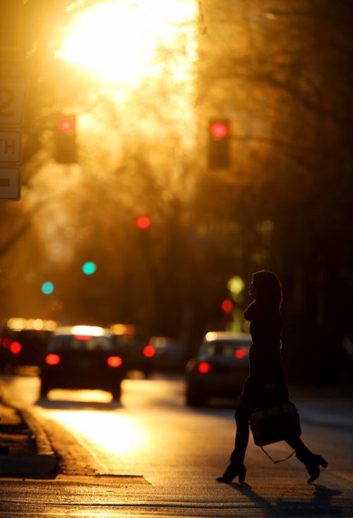 Pedestrians walk across Broadway in the setting sun, Thursday, October 17, 2013. (TREVOR HAGAN/WINNIPEG FREE PRESS)