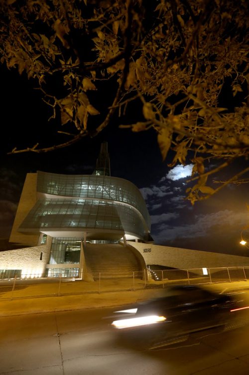 The Canadian Museum for Human Rights, with a nearly full moon behind clouds, Thursday, October 17, 2013. (TREVOR HAGAN/WINNIPEG FREE PRESS) CMHR