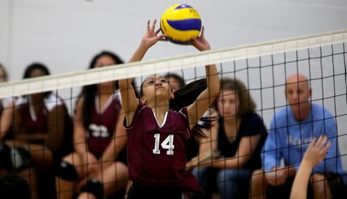 DMCI Maroons' Charisse Ahmad (14), setting during the teams junior varsity volleyball game at home against the Grant Park Pirates' Thursday, October 17, 2013. (TREVOR HAGAN/WINNIPEG FREE PRESS)