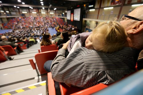 Jocelyn Beaudry, 2, and her grandfather, Rene Beaudry, at the University of Winnipeg Fall Convocation, inside Duckworth Centre, as Jocelyn's father, Alain graduates with his Masters of Economics, Friday, October 18, 2013. (TREVOR HAGAN/WINNIPEG FREE PRESS)