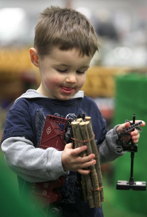 Two and a half year old Carson Ryder holds some model train pieces that he purchased with his dad while attending the MB Mega Train Show at Canlan Sports Centre Saturday afternoon.  The show is on Saturday and Sunday till 5pm.   Standup photo  Oct   19,, 2013 Ruth Bonneville Winnipeg Free Press