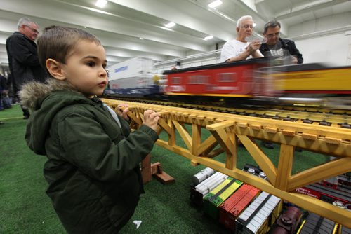 Four year old Alexander Ioannou is intrigued by the  model train sets moving along the life like tracks while attending the MB Mega Train Show at Canlan Sports Centre Saturday afternoon with dad.  The show is on Saturday and Sunday till 5pm.   Standup photo  Oct   19,, 2013 Ruth Bonneville Winnipeg Free Press