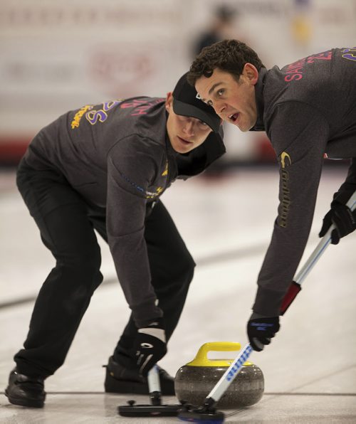 Tyrel Griffith and Rick Sawatsky of Team Morris look towards the house as they sweep. Team Morris would go on to defeat Team Arkhipov 7-1, October 20, 2013 (GREG GALLINGER / WINNIPEG FREE PRESS)