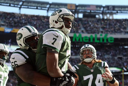 Oct 20, 2013; East Rutherford, NJ, USA; New York Jets quarterback Geno Smith (7) celebrates his touchdown run during the second half of their game against the New England Patriots at MetLife Stadium. Mandatory Credit: Ed Mulholland-USA TODAY Sports - RTX14HZD