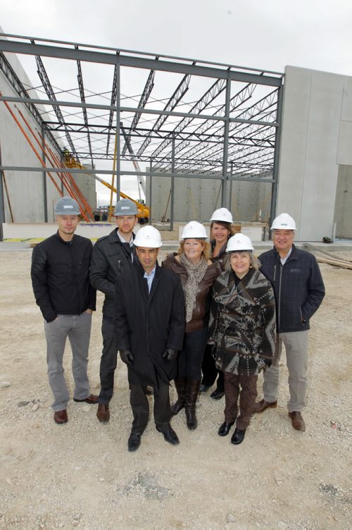 Bird Construction project manager Nathan Wiebe, Bird Construction District Manager Paul Bergman, Sindico Realty Inc. manager of industrial properties Robert Scaletta, CentrePort Canada Inc CEO Diane Gray, Rosser Ward 3 councillor Angela Emms, Rural Municipality of Rosser reeve Frances Smee, and Bird Construction Design Manager Richard Marshall pose for a photo in front of the partially constructed building. Davis Way and Mountain View Rd.To go with story on construction of mulit-use industrial building on the CentrePort grounds. BORIS MINKEVICH / WINNIPEG FREE PRESS Oct. 21, 2013